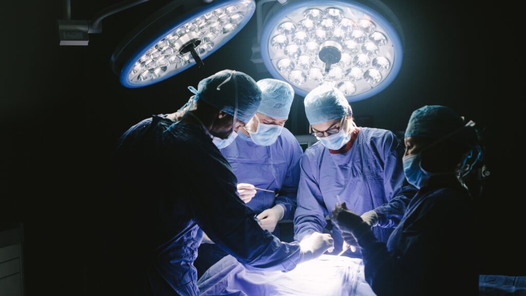 Doctor performing bone marrow transplant procedure in a hospital setting